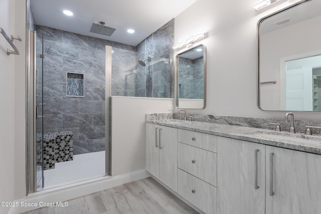 bathroom with vanity, hardwood / wood-style floors, and walk in shower