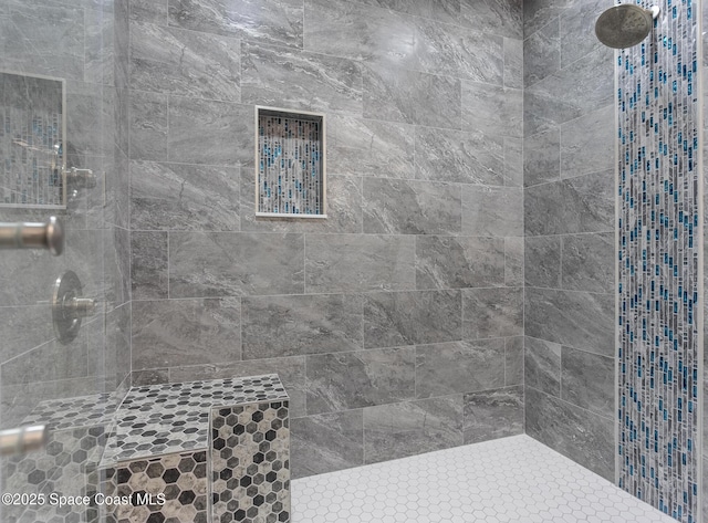 bathroom featuring a tile shower