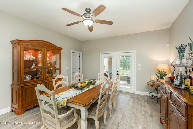 dining area with french doors, ceiling fan, and light wood-type flooring