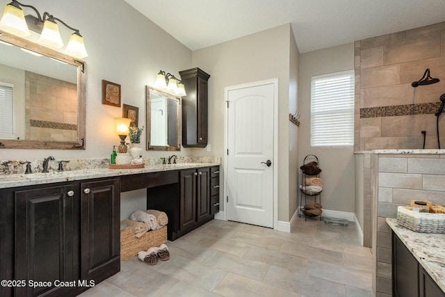 bathroom with vanity and tiled shower