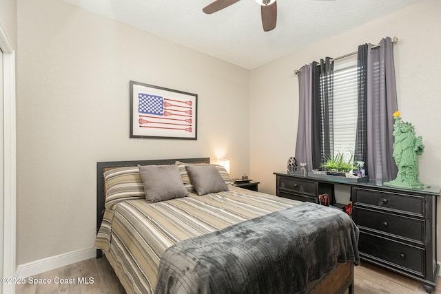 bedroom featuring light hardwood / wood-style flooring and ceiling fan