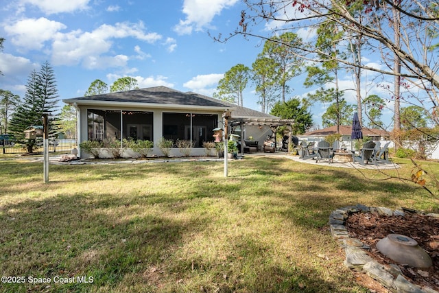 back of property with a pergola, a lawn, a sunroom, and a patio