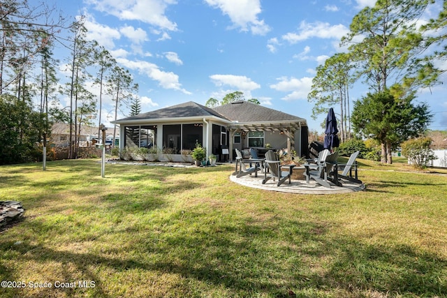 back of house with a patio, a sunroom, a lawn, and a fire pit