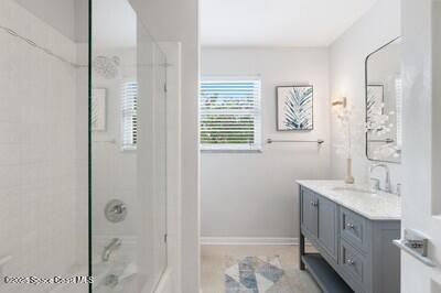 bathroom with vanity and a tile shower