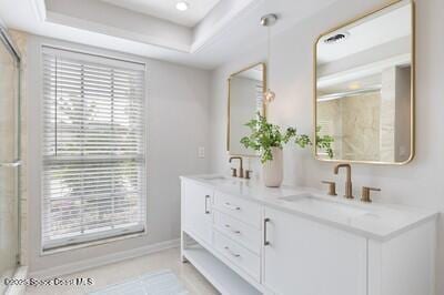 bathroom featuring a shower with door, vanity, tile patterned flooring, and a tray ceiling