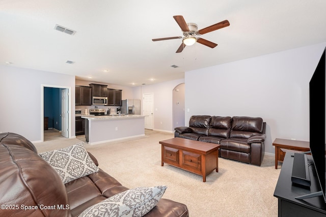 living room with light carpet and ceiling fan