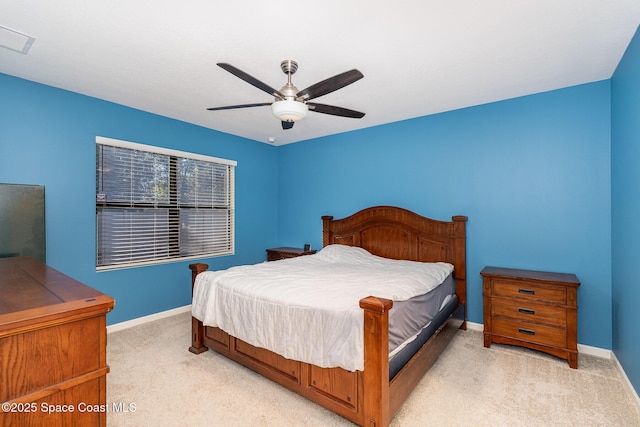 bedroom with ceiling fan and light carpet