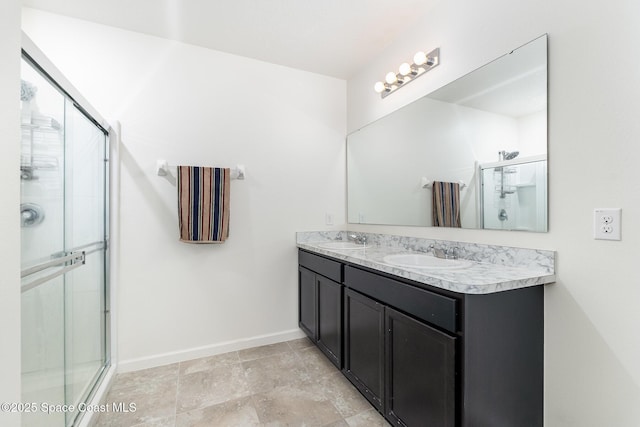 bathroom featuring vanity and a shower with door