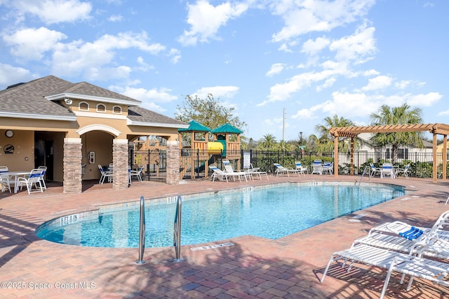 view of pool with a patio and a playground