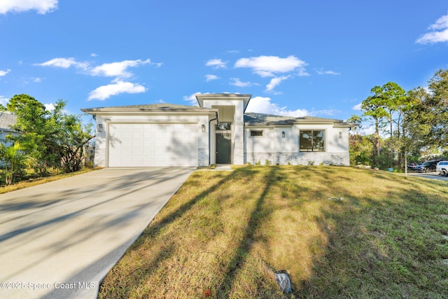 view of front of home with a garage and a front lawn