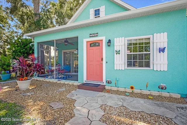 entrance to property featuring ceiling fan