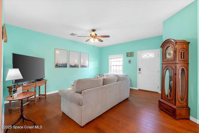 living room featuring hardwood / wood-style floors and ceiling fan