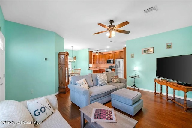 living room featuring hardwood / wood-style floors and ceiling fan