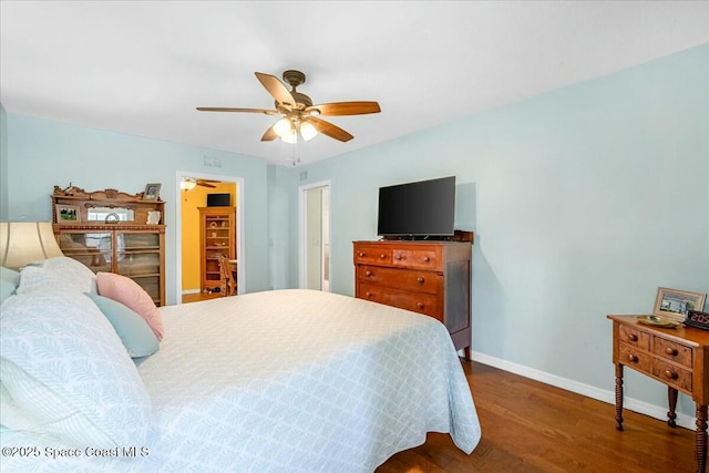 bedroom with ceiling fan and dark hardwood / wood-style floors