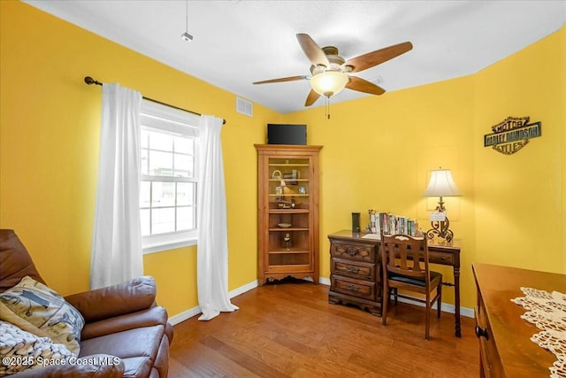 home office with wood-type flooring and ceiling fan