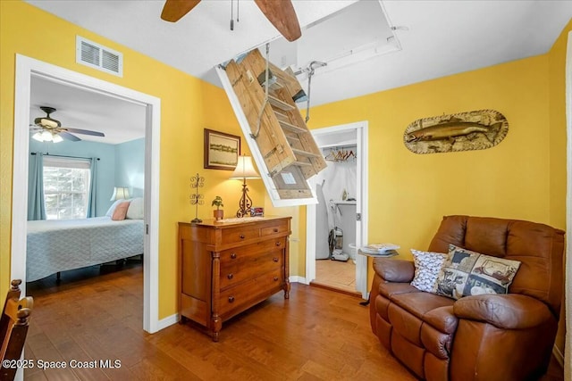 sitting room with ceiling fan and hardwood / wood-style floors