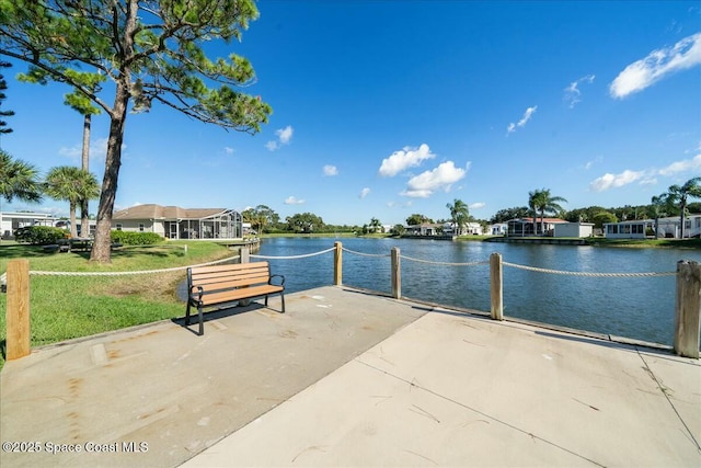 view of community with a lawn and a water view