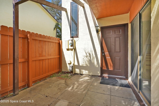 entrance to property with a patio