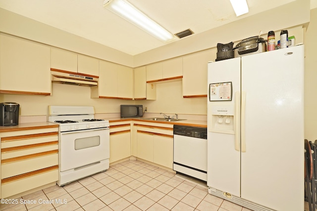 kitchen featuring sink, white appliances, and light tile patterned floors