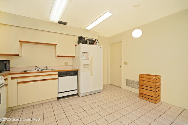 kitchen featuring hanging light fixtures, sink, and white appliances