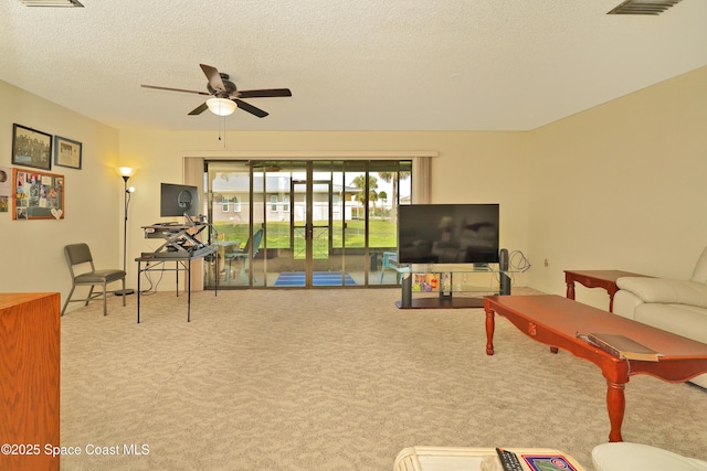 living room with light carpet, a textured ceiling, and ceiling fan