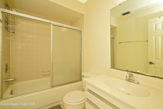 full bathroom featuring vanity, toilet, and combined bath / shower with glass door