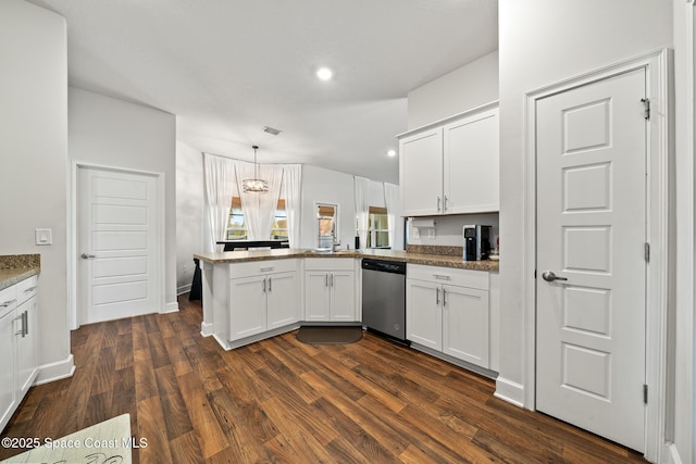 kitchen with hanging light fixtures, white cabinets, dark hardwood / wood-style flooring, stainless steel dishwasher, and kitchen peninsula