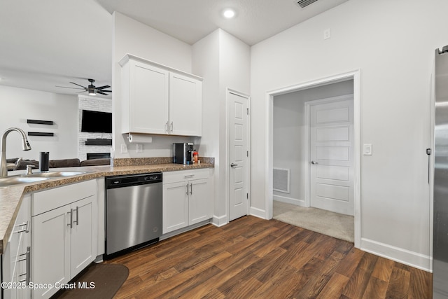 kitchen featuring dark hardwood / wood-style flooring, sink, stainless steel dishwasher, and white cabinets