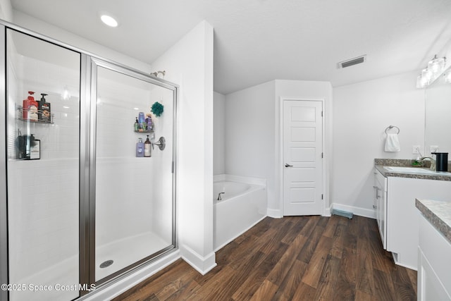 bathroom featuring vanity, separate shower and tub, and wood-type flooring