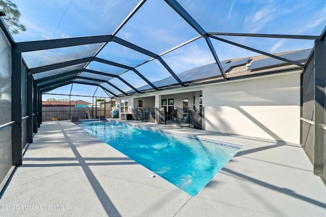 view of swimming pool with a patio and glass enclosure