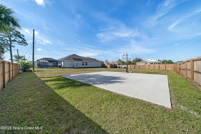 view of basketball court with a yard