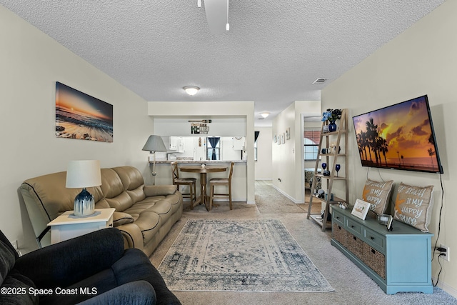 living room with light colored carpet and a textured ceiling