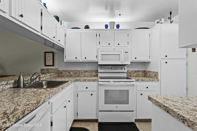 kitchen featuring white cabinetry, sink, and white appliances