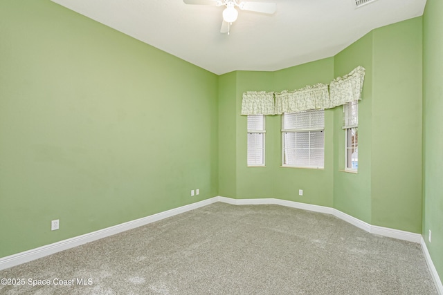 carpeted spare room featuring ceiling fan