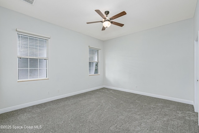 empty room featuring carpet floors and ceiling fan