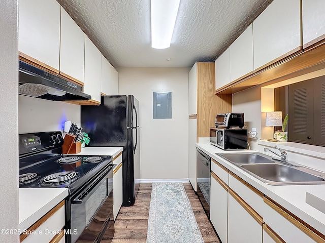 kitchen featuring dark hardwood / wood-style flooring, sink, black appliances, and white cabinets