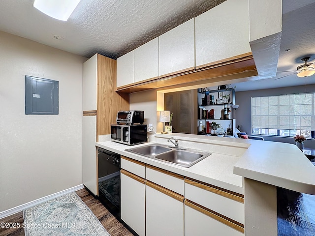 kitchen featuring sink, electric panel, black dishwasher, a textured ceiling, and kitchen peninsula