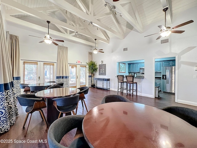 dining area with dark hardwood / wood-style flooring, wood ceiling, beam ceiling, and french doors