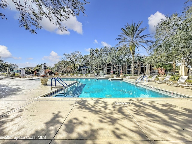 view of swimming pool featuring a patio area