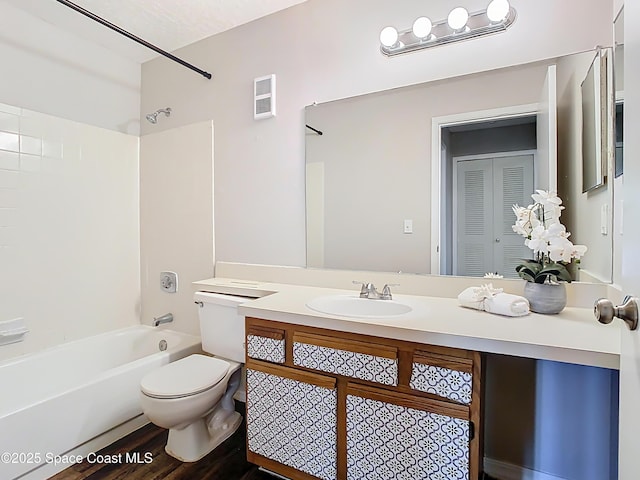 7667 N Wickham Rd Unit 721, Melbourne, FL 32940 - full bathroom with visible vents, wood finished floors, vanity, toilet, and tub / shower combination