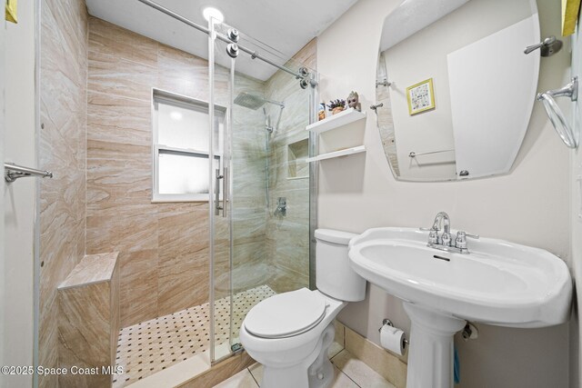 bathroom with a stall shower and toilet