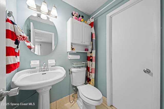 full bathroom with toilet and tile patterned floors