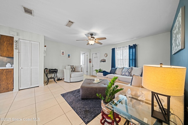 tiled living area featuring ceiling fan and visible vents