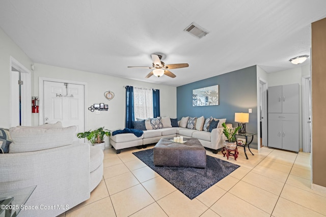 living area featuring visible vents, a ceiling fan, and light tile patterned flooring