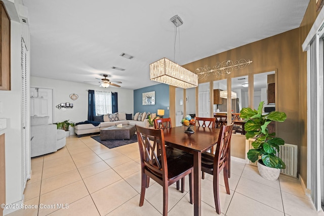 dining room featuring a ceiling fan, visible vents, and light tile patterned floors