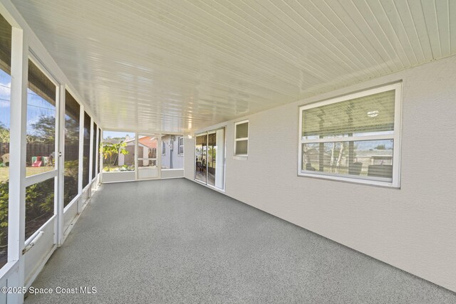 unfurnished sunroom with wood ceiling