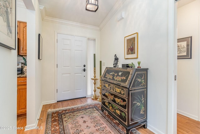 foyer featuring light hardwood / wood-style flooring and ornamental molding