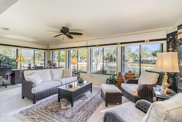 sunroom / solarium with a water view and ceiling fan