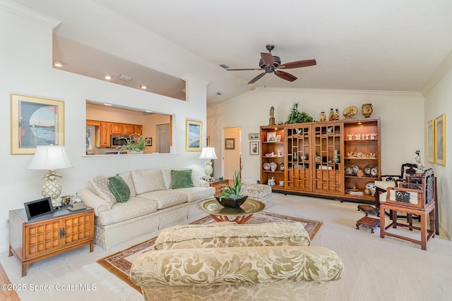 living room featuring ornamental molding, lofted ceiling, light carpet, and ceiling fan