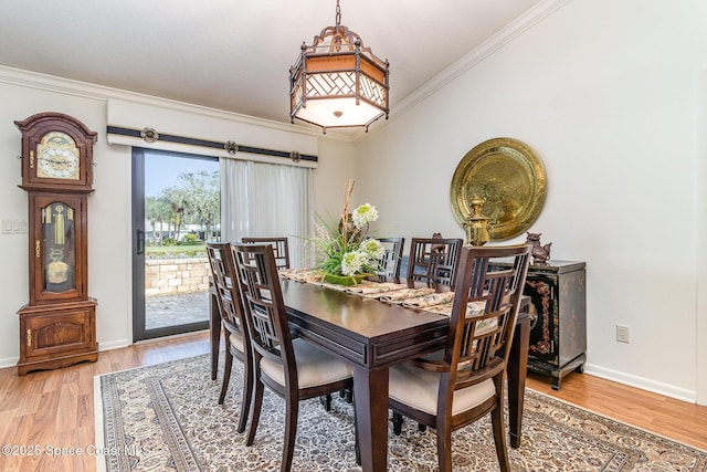 dining area featuring ornamental molding and wood-type flooring